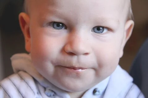 Open image of a small boy looking into the camera.