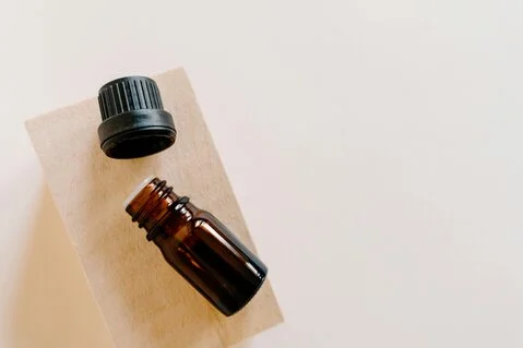 Open essential oil bottle lying on its side<br />